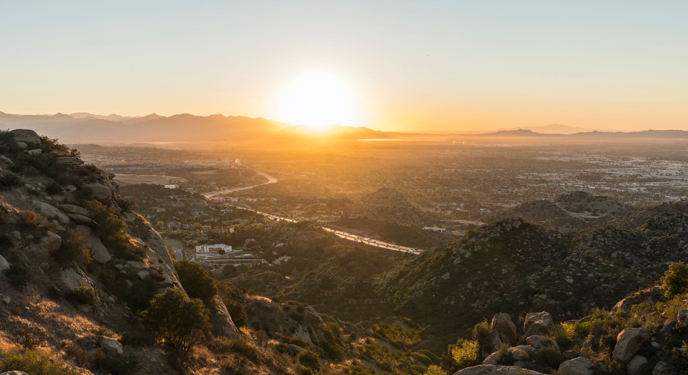 Sunrise over mountains and valley landscape.